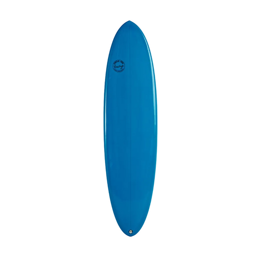 A bright blue egg surfboard standing vertically against a plain white wall, with a small circular logo near the top center.