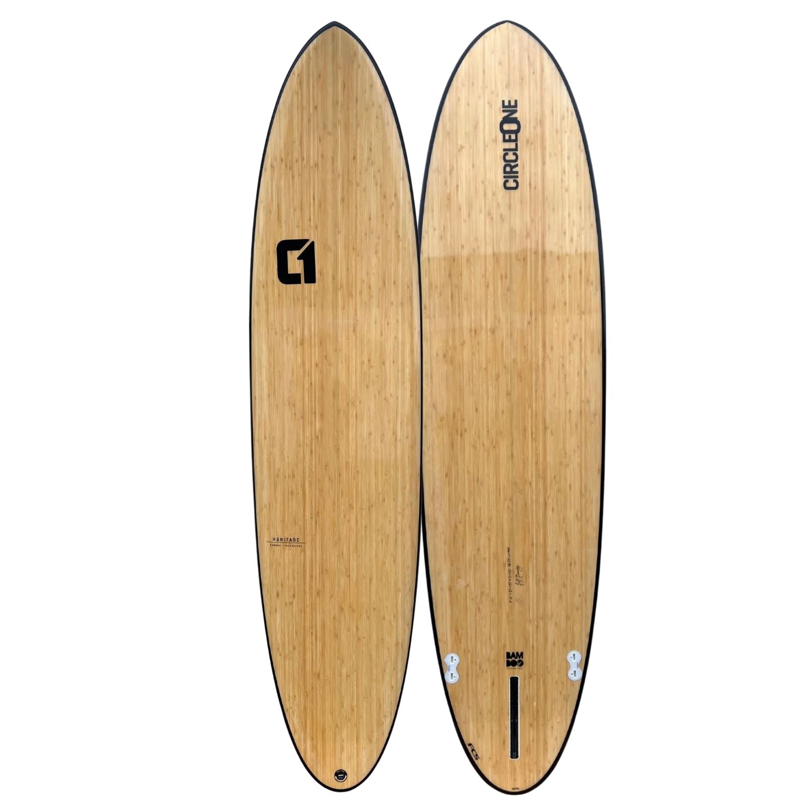Wooden surfboard with brand logos on a white background