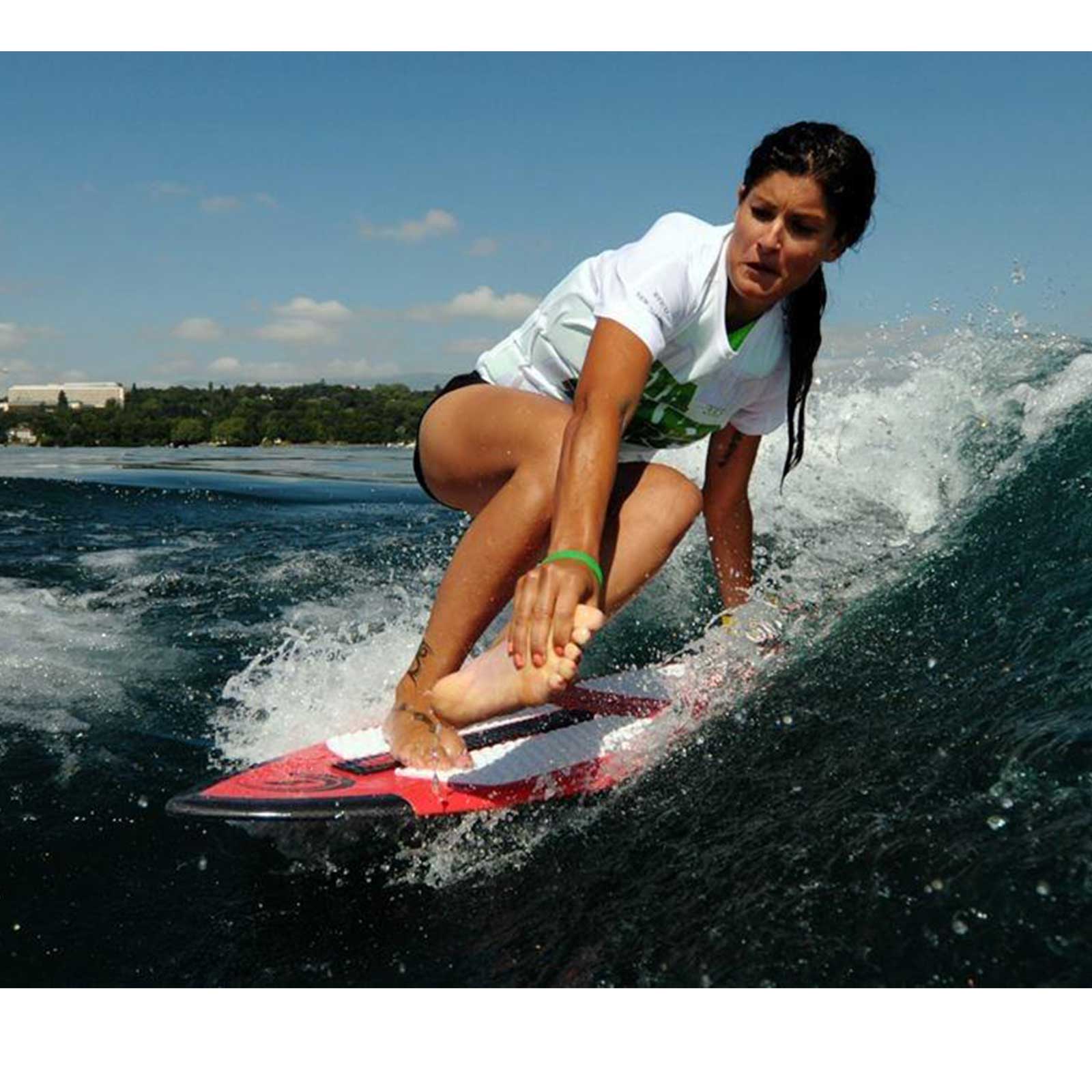 Person surfing on a wave with a clear sky in the background
