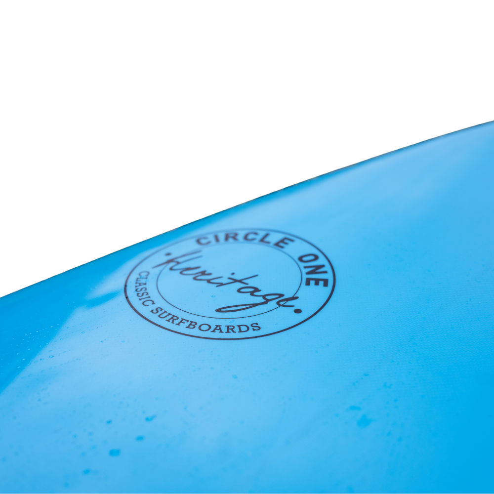 Blue egg surfboard with 'Circle One Heritage' logo on a white background